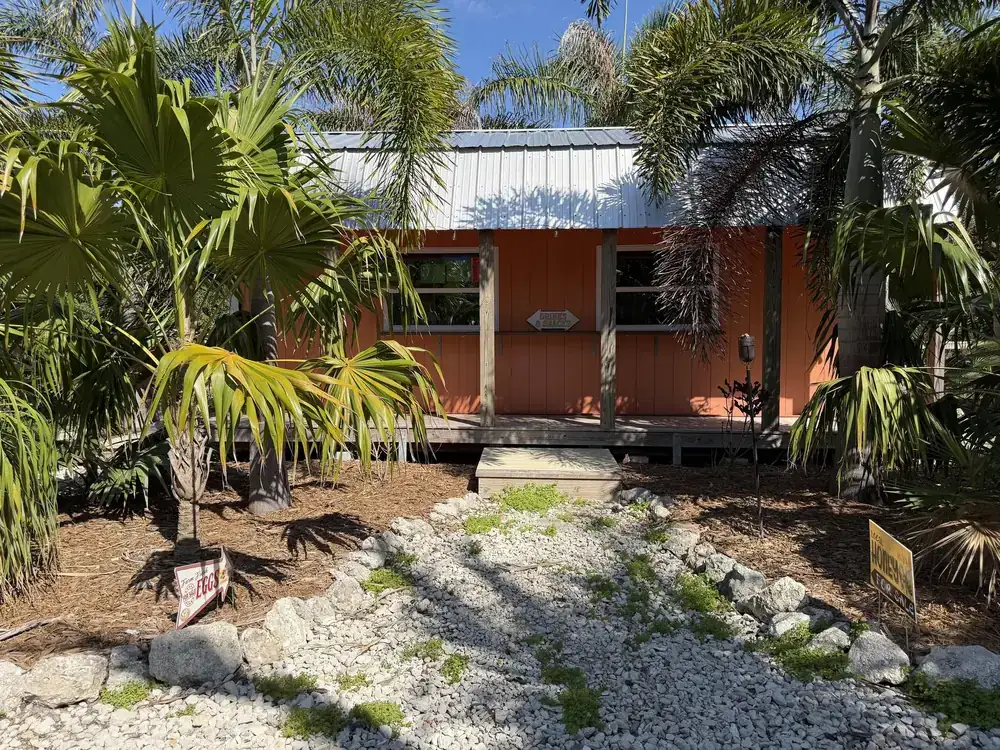 The orange snack shack building with a drinks and snacks sign